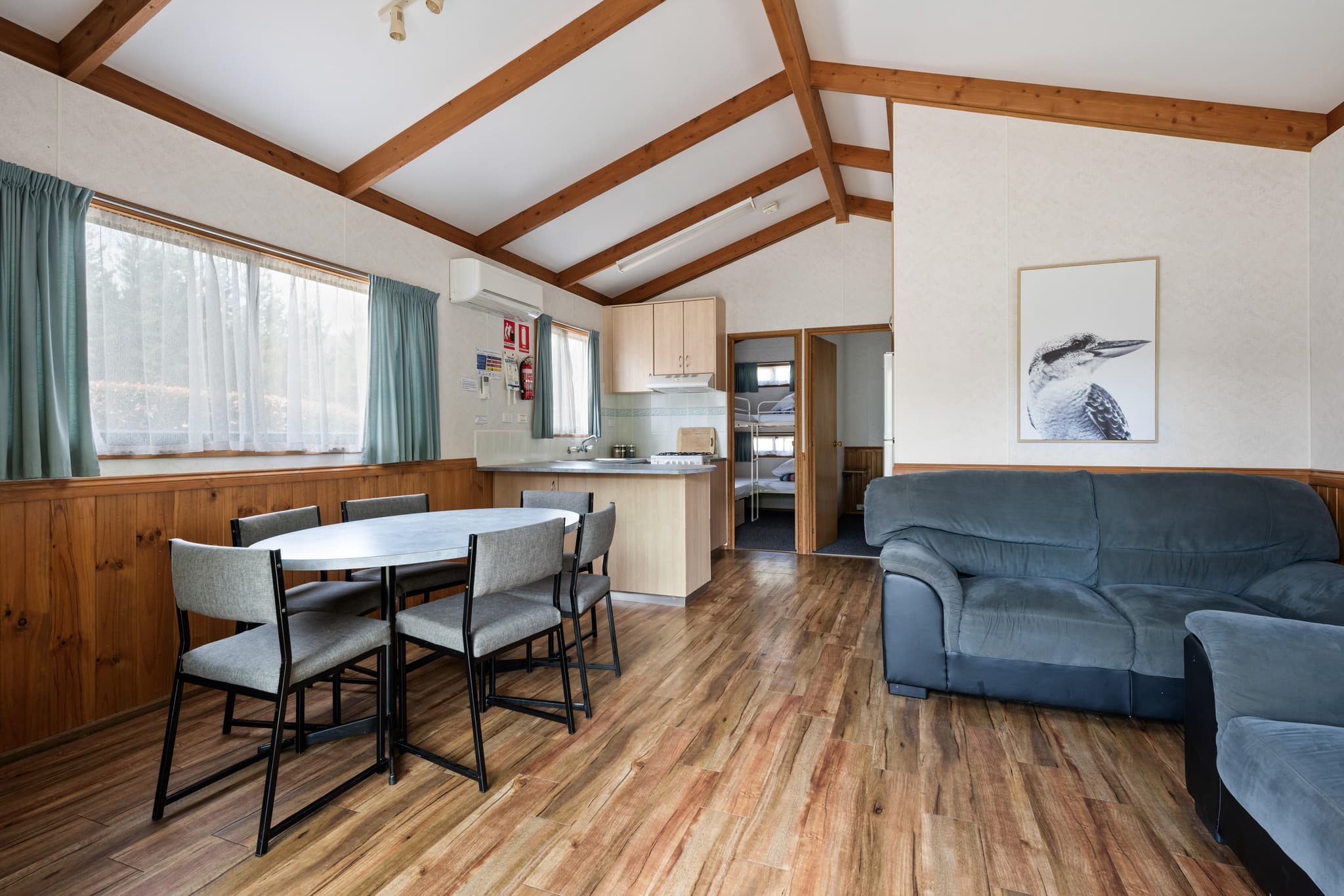 Supreme Villa interior at Bright Accommodation Park with exposed timber beams, open-plan kitchen, dining area and lounge