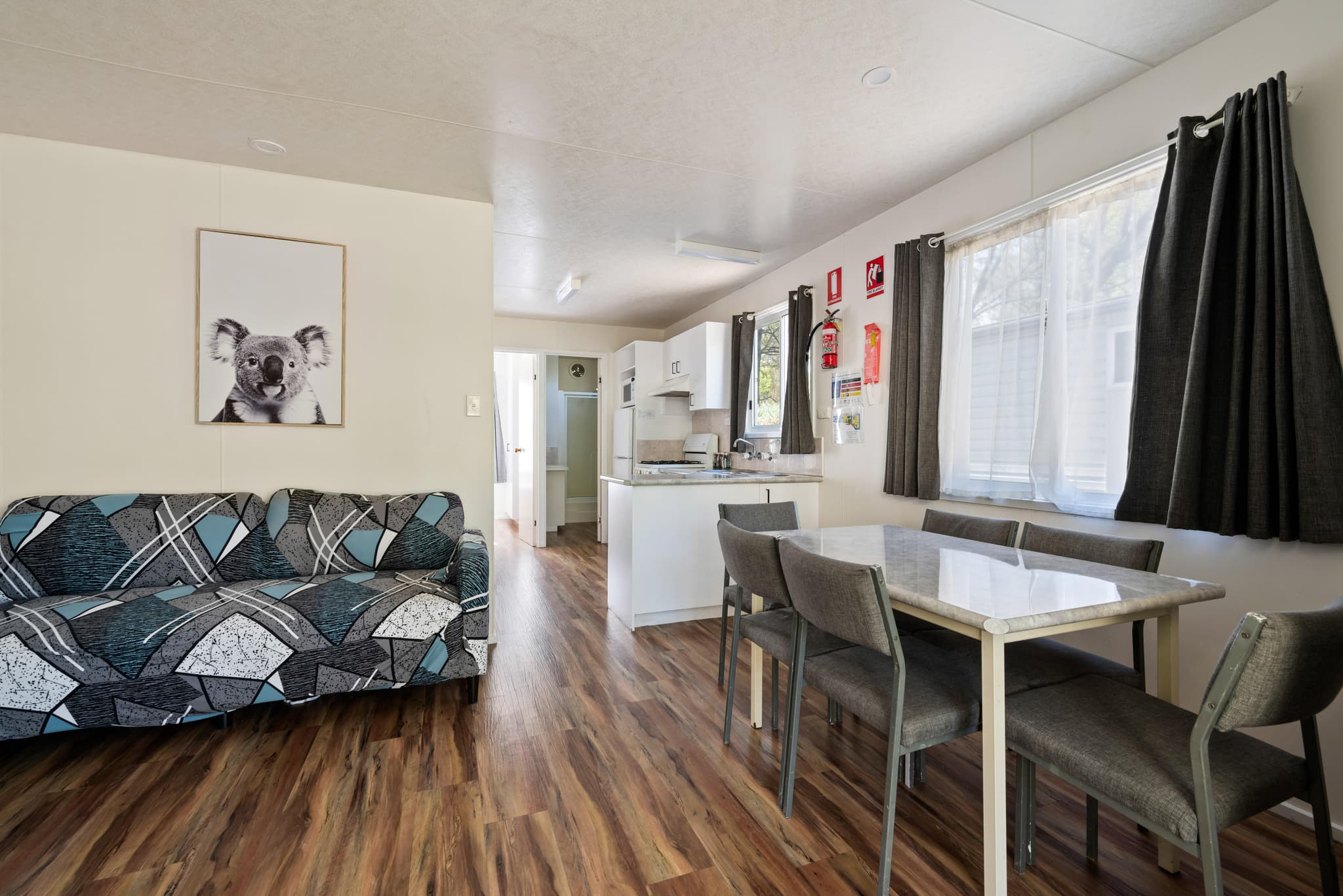 Bright Accommodation Park Bogong cabin interior with lounge, dining table and modern kitchen in Bright VIC