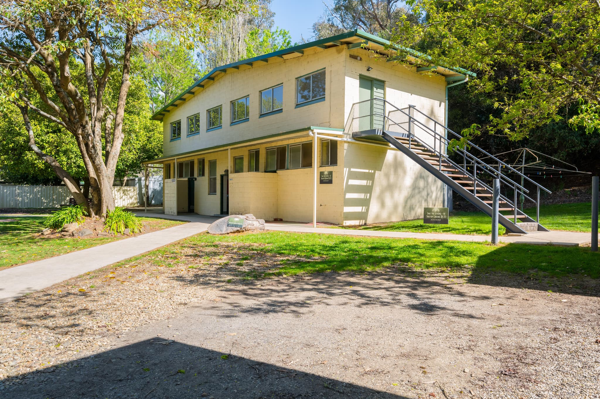 Treetops Queen dorm building with green roof and external staircase at Bright Accommodation Park, Great Alpine Road